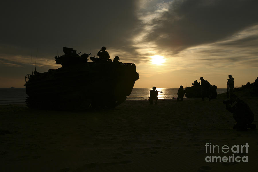 Sunset Photograph - Silhouette Of Marines And An Amphibious by Stocktrek Images