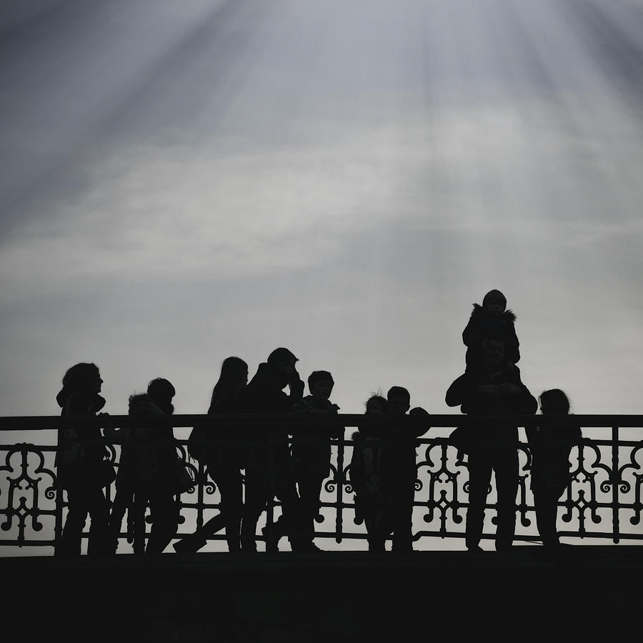 Silhouette Of People On A Bridge Photograph