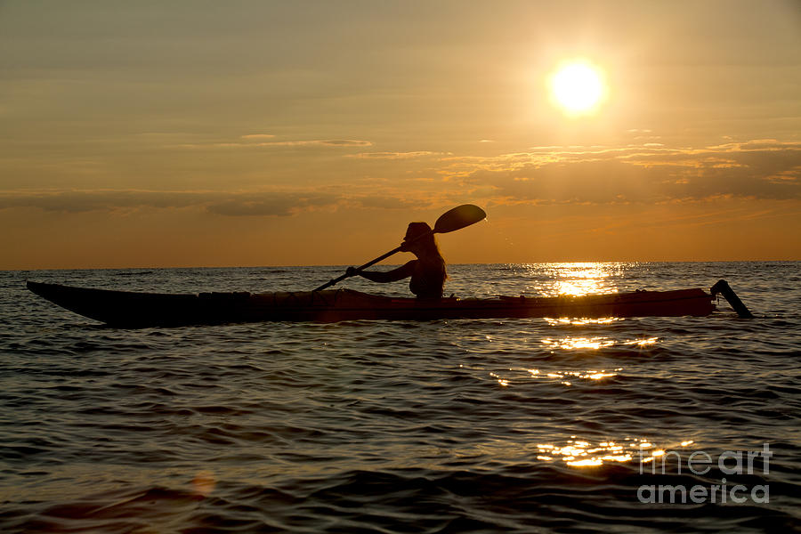 Silhouette of woman kayaking in the ocean. Photograph by Anthony Totah