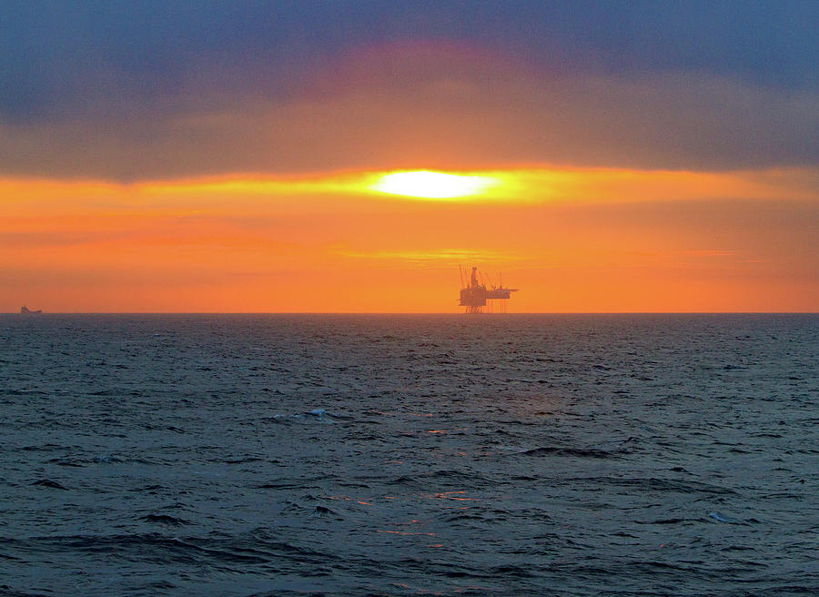 Silhouetted oil drilling platform  Photograph by Allan Levin