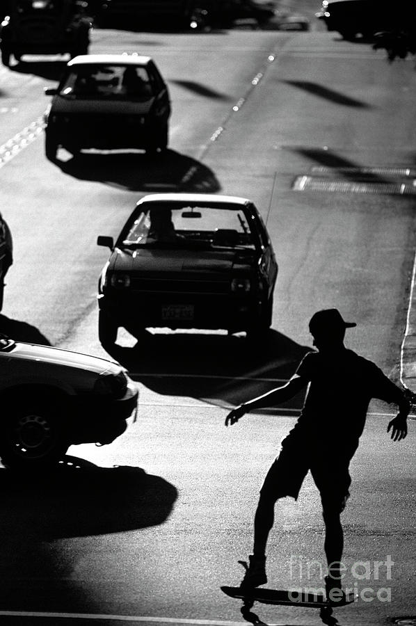 Silhouetted Skateboarder along the Ave Photograph by Jim Corwin