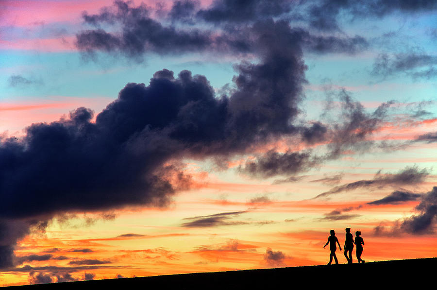 Silhouettes of three girls walking in the sunset Photograph by Fabrizio Troiani