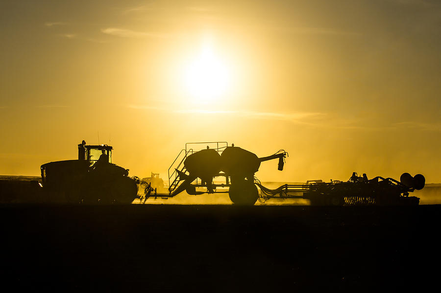 Sillhouette of Tractors Planting Wheat Photograph by Todd Klassy