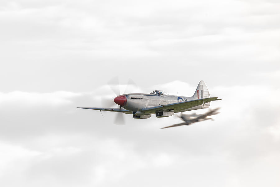 Silver Spitfire in a cloudy sky Photograph by Gary Eason