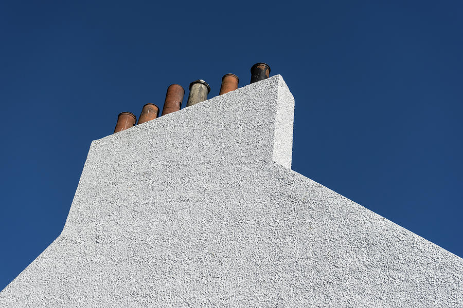 Simplicity - White Stucco Wall and Chimneys Photograph by Georgia Mizuleva