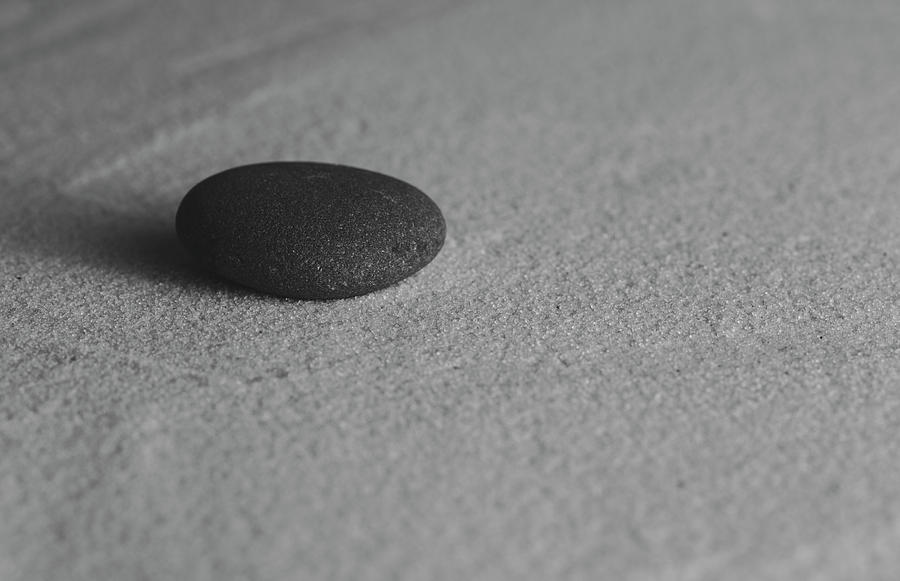 Single Meditation Stone on Smooth Sand Black and White Photograph by Andrew Pacheco