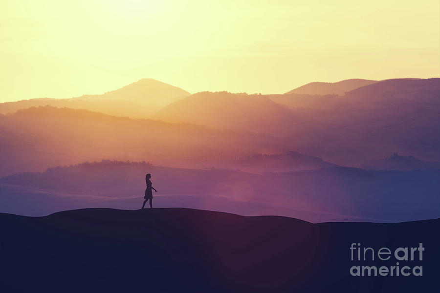 Single woman walking on the hill during sunset. Photograph by Michal Bednarek