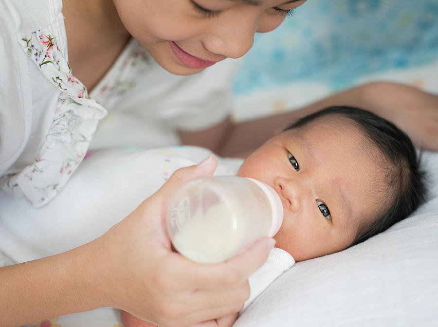 Sister takecare asian new born baby  Photograph by Anek Suwannaphoom