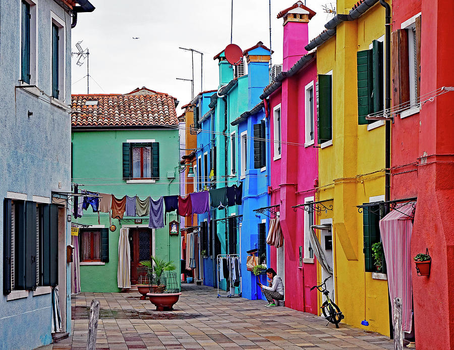 Sitting On A Stoop Texting On The Island Of Burano In The Venetian Lagoon Photograph by Rick Rosenshein