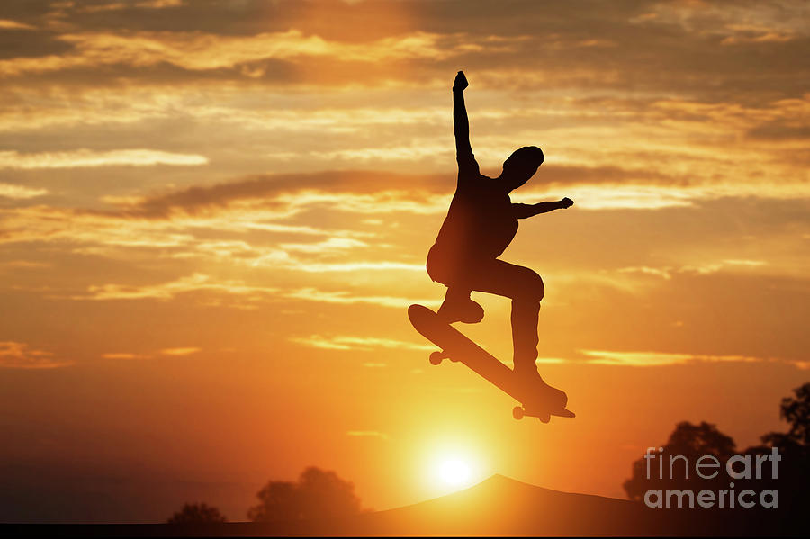 Skateboarder jumping at sunset. Photograph by Michal Bednarek