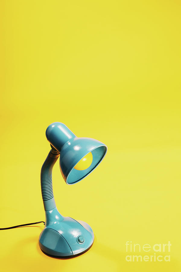 Sky-blue desk lamp on yellow background. Photograph by Michal Bednarek
