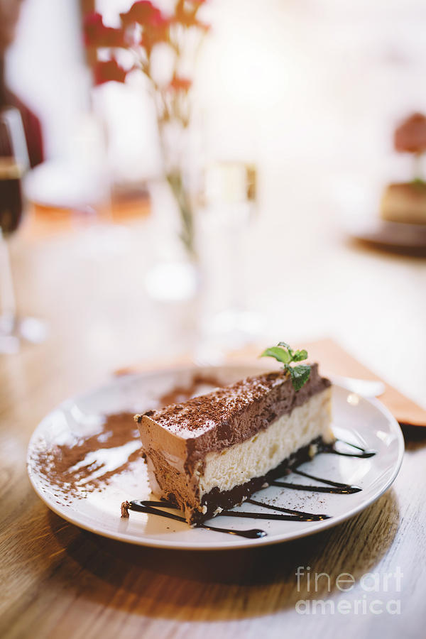Slice of cheesecake served on a decorated plate. Photograph by Michal Bednarek