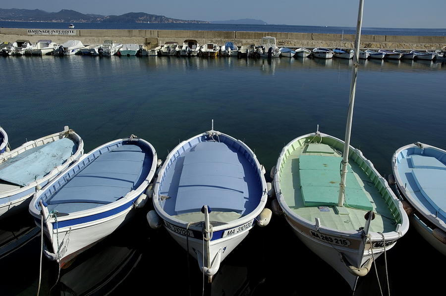 Small fishing boats lined up in a near row Photograph by Sami Sarkis