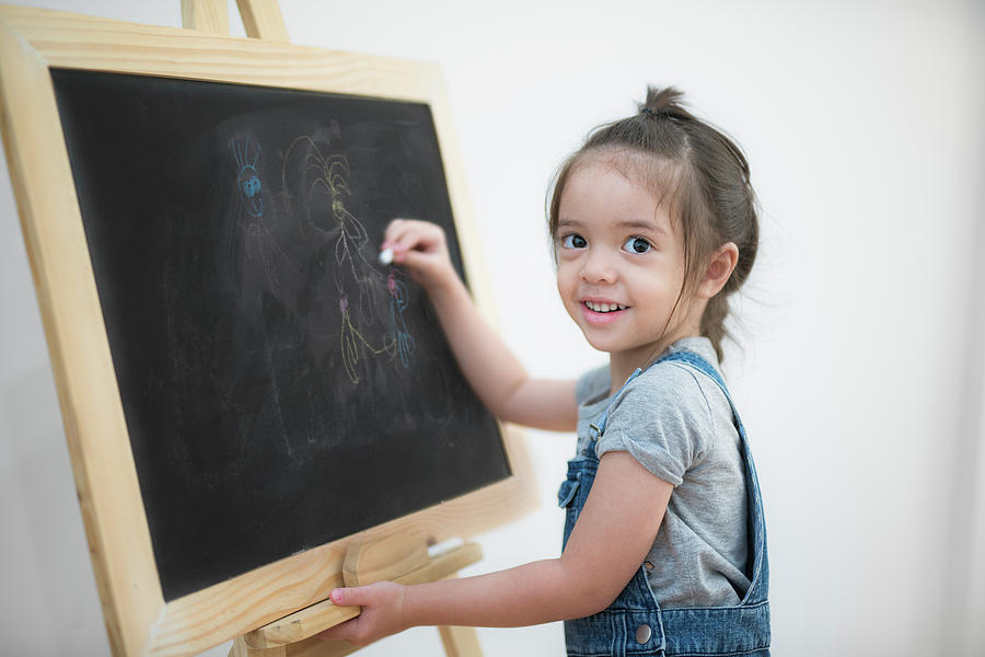 Smile girl draw cartoon with chalk and blackboard Photograph by Anek Suwannaphoom
