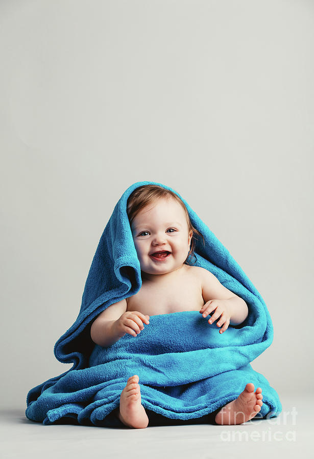 Smiling baby tucked in a warm blanket Photograph by Michal Bednarek