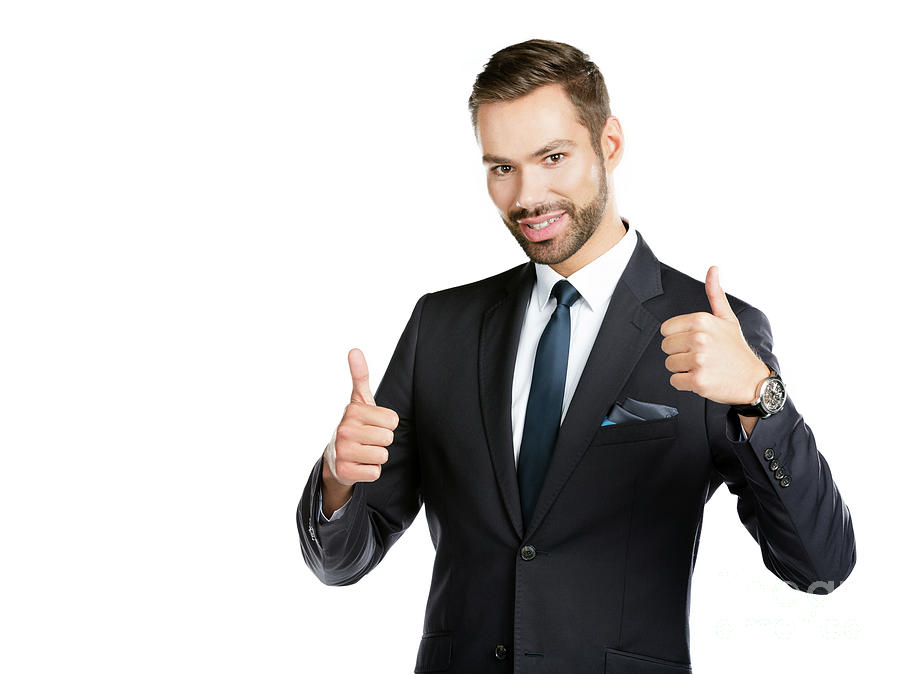 Smiling businessman with thumbs up. Photograph by Michal Bednarek