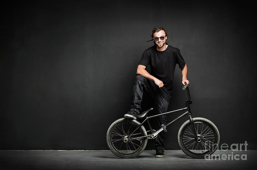 Smiling man with dreadlocks standing with his BMX Photograph by Michal Bednarek
