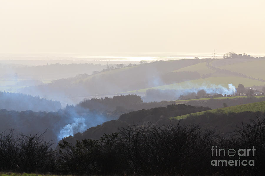 Smoke rising on hilly hazy landscape Photograph by Peter Noyce