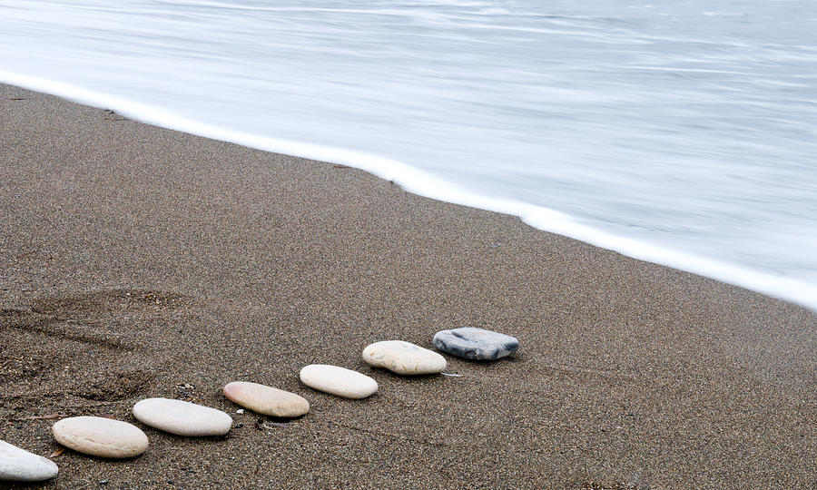 Smooth beach stones in a row Photograph by Michalakis Ppalis