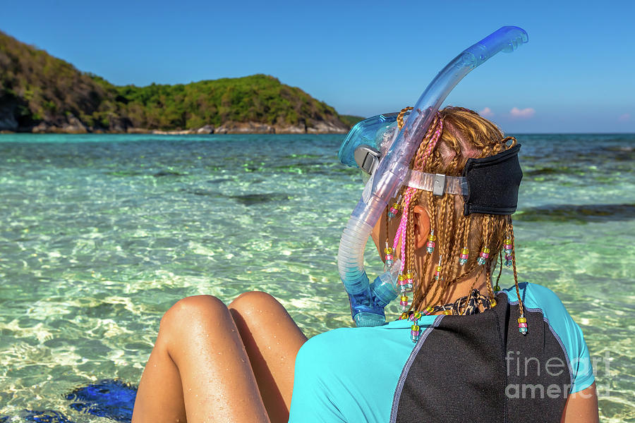 Snorkeler relaxing on tropical beach Photograph by Benny Marty