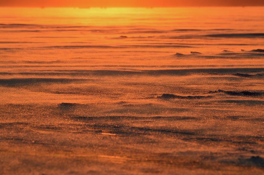 Snow Blowing Across The Ice At Sunset Photograph by Lyle Crump