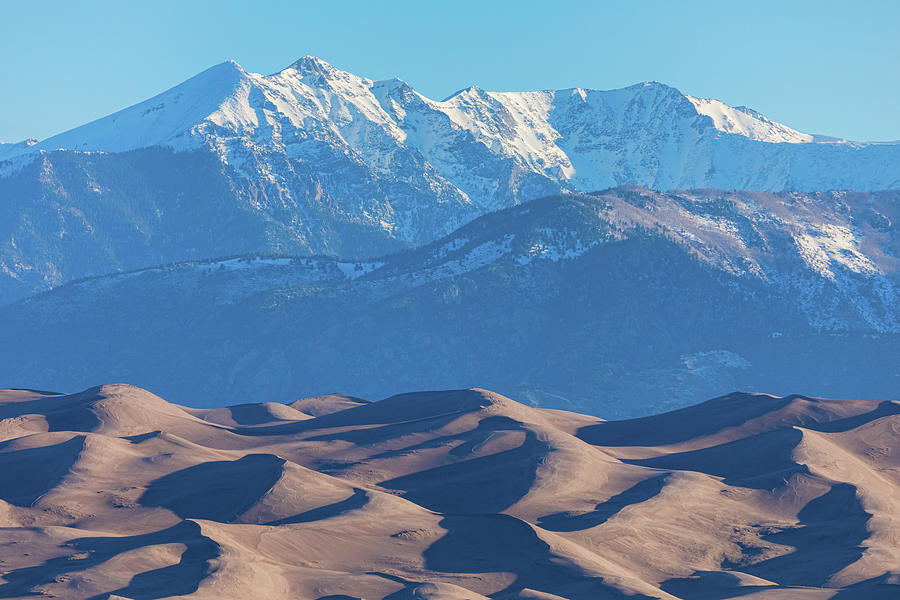 Snow Covered Rocky Mountain Peaks With Sand Dunes Photograph