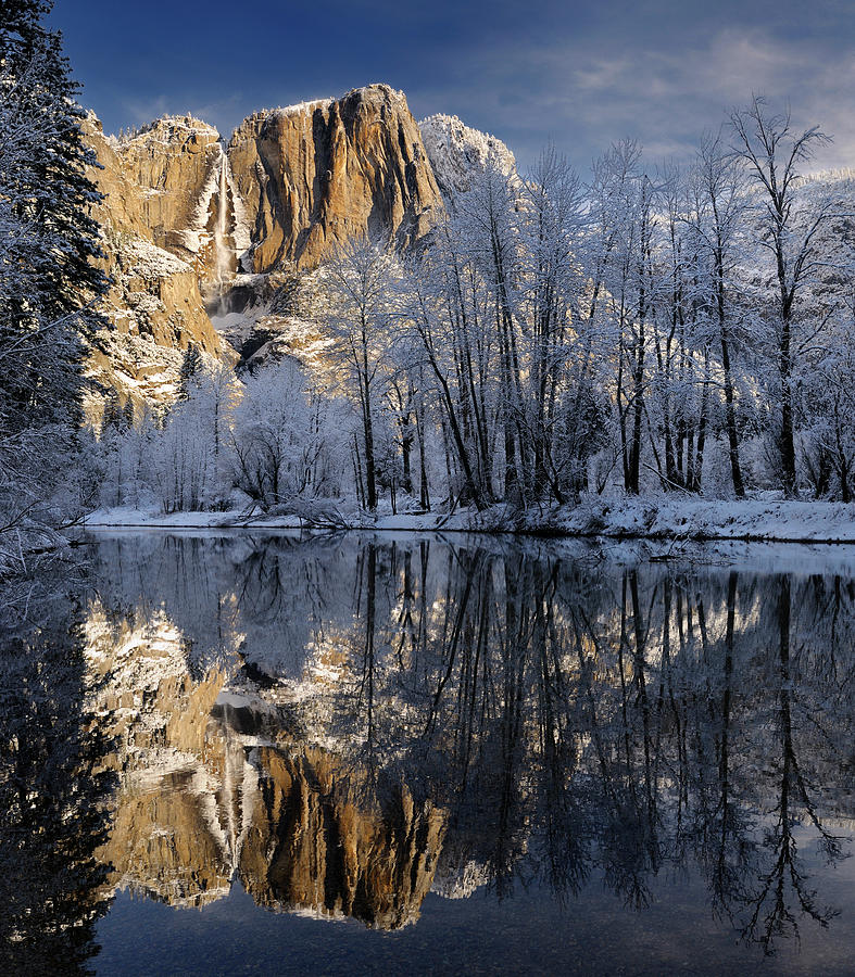 Snow covered trees and Yosemite Point and the Upper Fall reflect