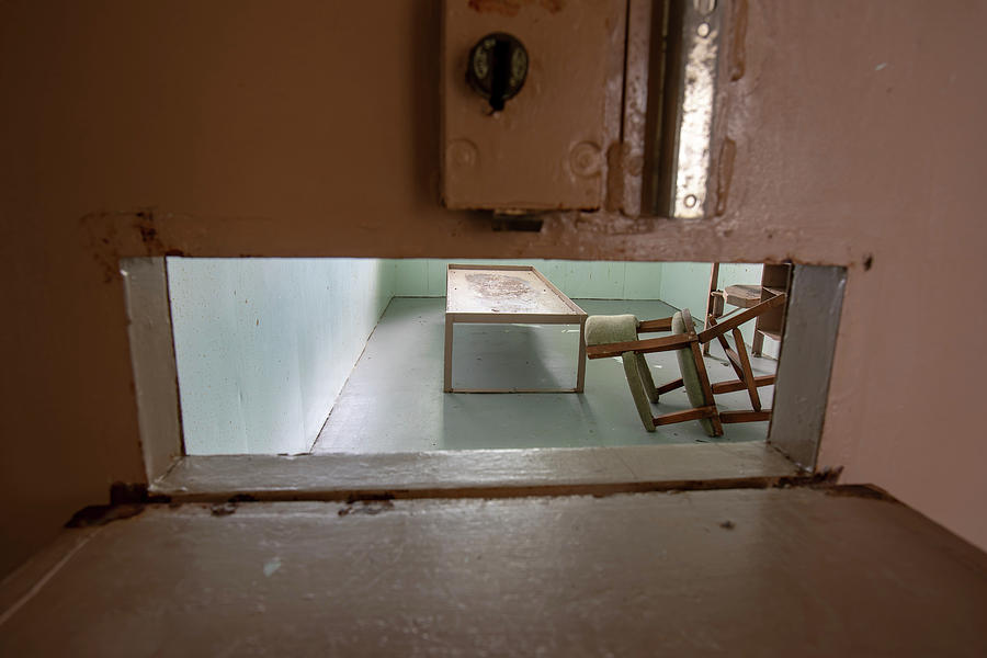 Solitary confinement cell through door slat Photograph by Karen Foley