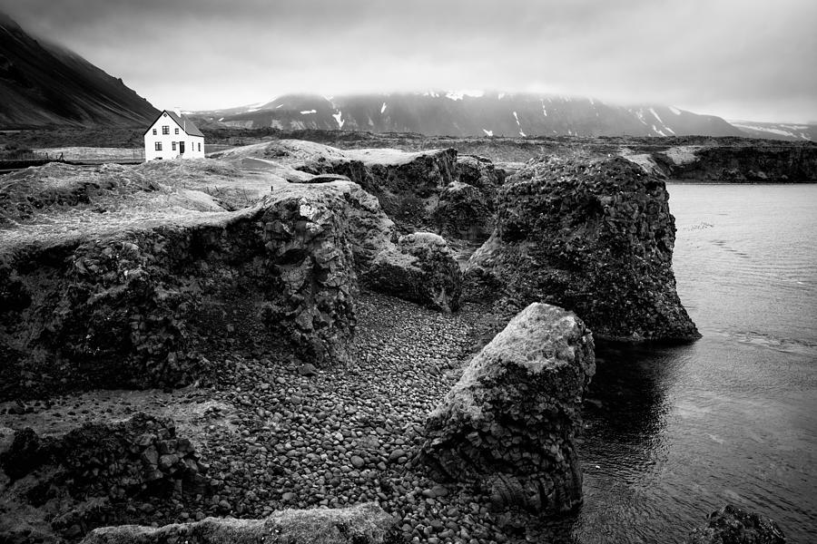 Solitary house at Arnarstapi coast Iceland black and white Photograph by Matthias Hauser