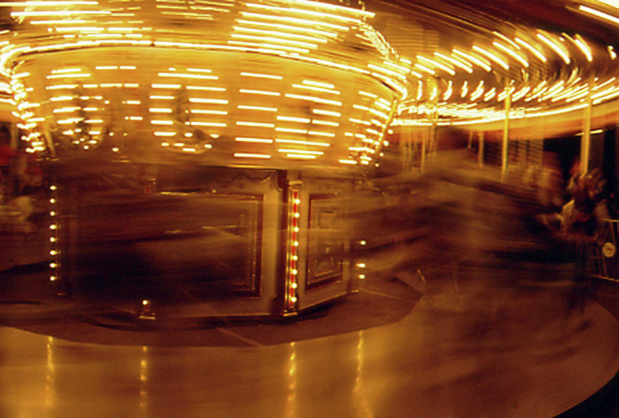 Speeding carousel Photograph by Gary Brandes