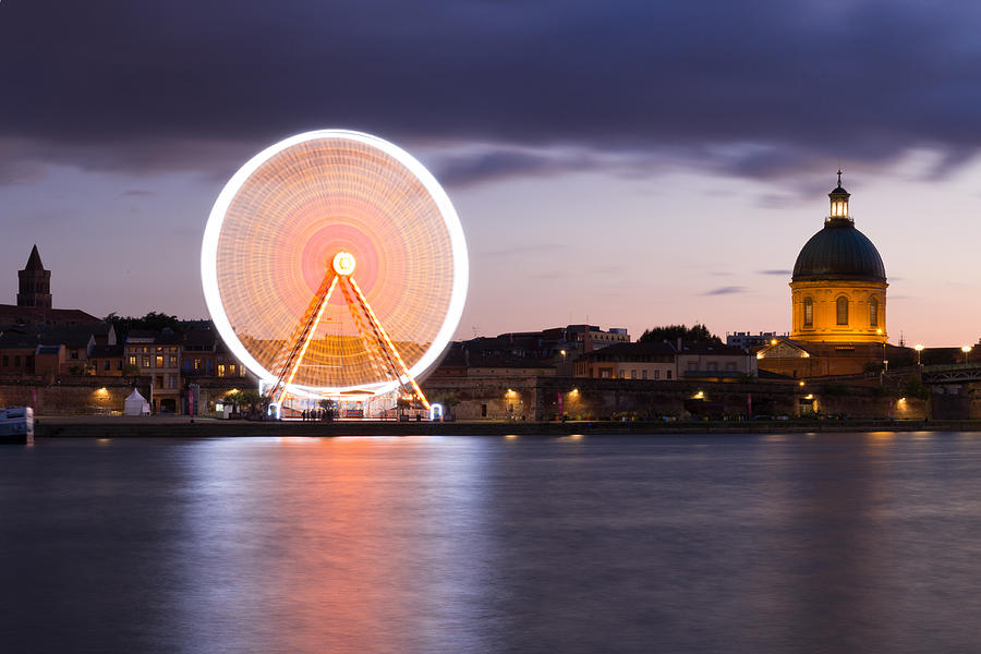 Spinning ferris wheel and the Chapelle at night in Toulouse Photograph by Semmick Photo
