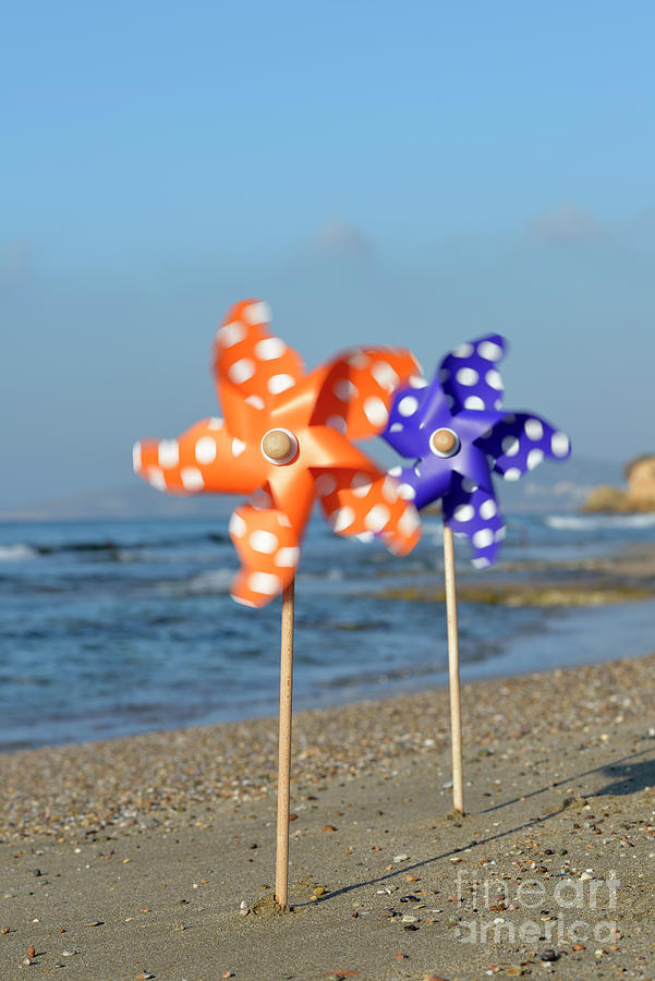 Spinning pinwheels on a beach Photograph by George Atsametakis