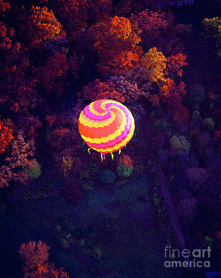 Spiral colored hot air balloon over fall tree tops Mchenry   Photograph by Tom Jelen