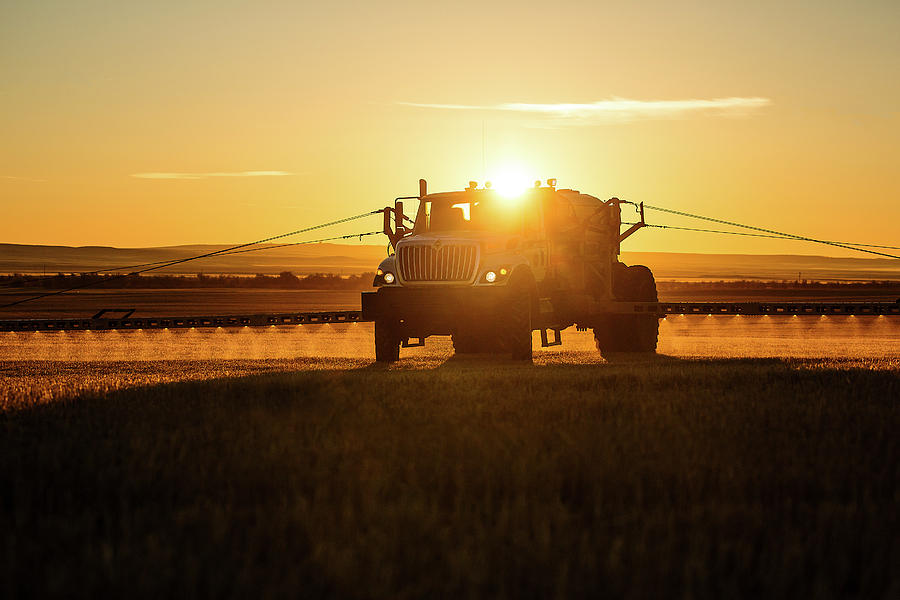 Spraying Wheat Photograph by Todd Klassy