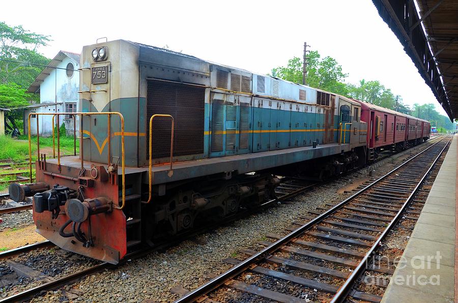 Sri Lankan Railways locomotive train engine with passenger carriages parked at station Photograph by Imran Ahmed