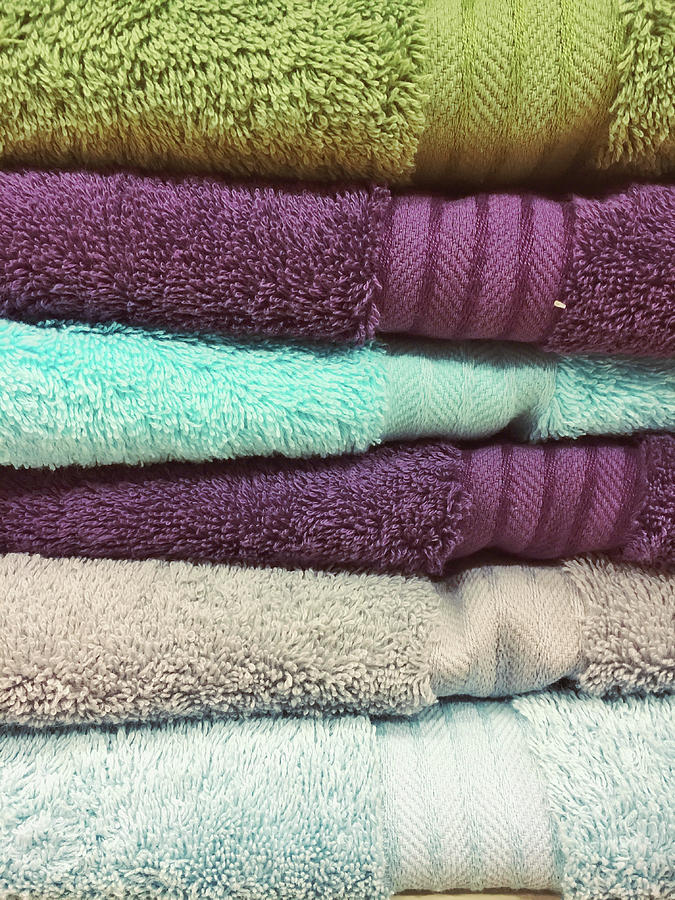 Stack of colourful towels Photograph by Tom Gowanlock