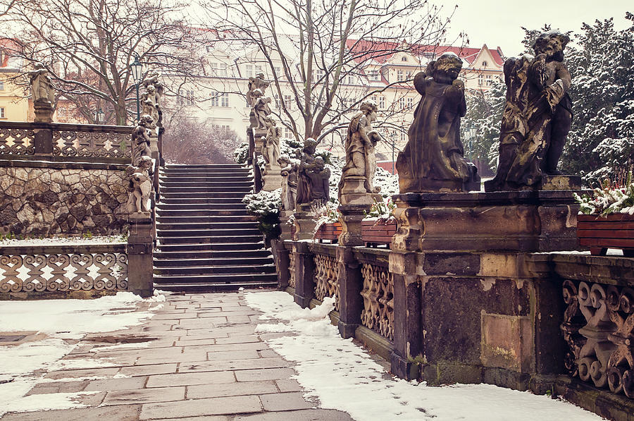 Staircase and Sculptures of Cherubs in Loreta Complex. Snowy Walk in Prague Photograph by Jenny Rainbow