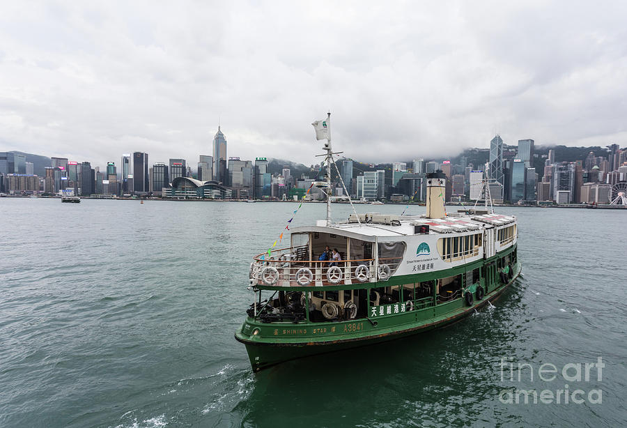 Star Ferry between Kowloon and Hong Kong island on cloudy day Photograph by Didier Marti