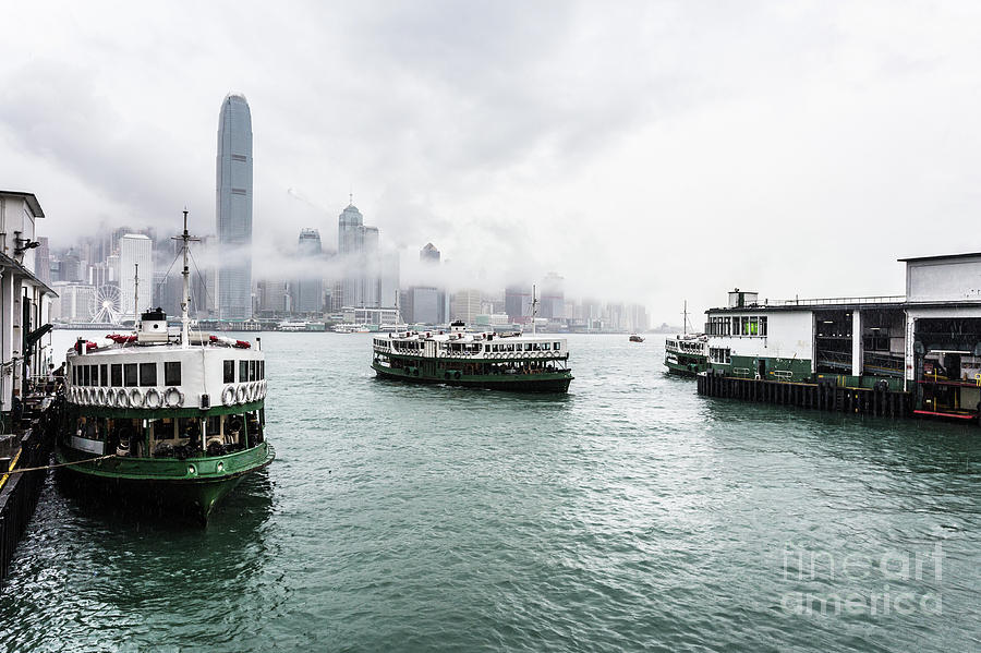 Star ferry on a cloudy sky with the famous skyline in Hong Kong. Photograph by Didier Marti