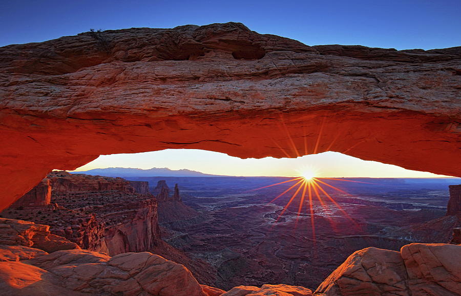 Starburst sunrise at Mesa Arch in Canyonlands National Park Photograph by Jetson Nguyen