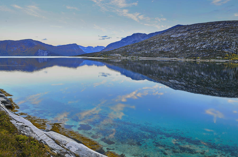 Stark Mountains Are Reflected In The Calm Water Of Fjord Ejfjorden Photograph