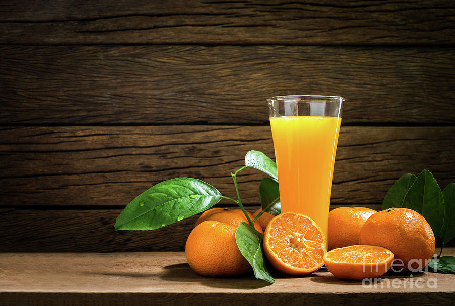 Juice In Glass Jar And Orange On Kitchen Table. Stock Photo