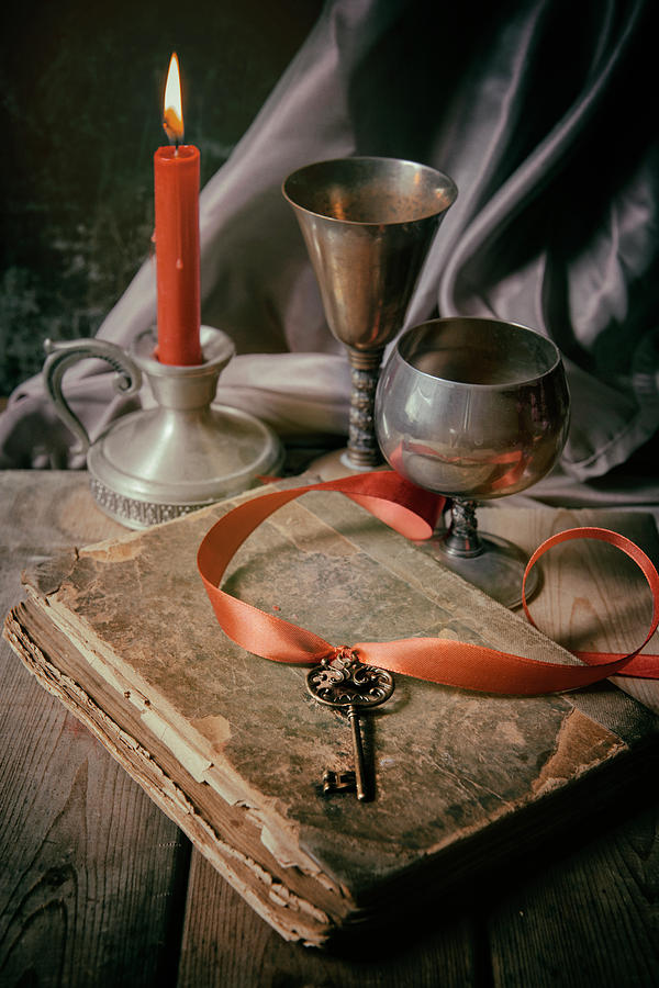 Still life with old book and metal dishes Photograph by Jaroslaw Blaminsky