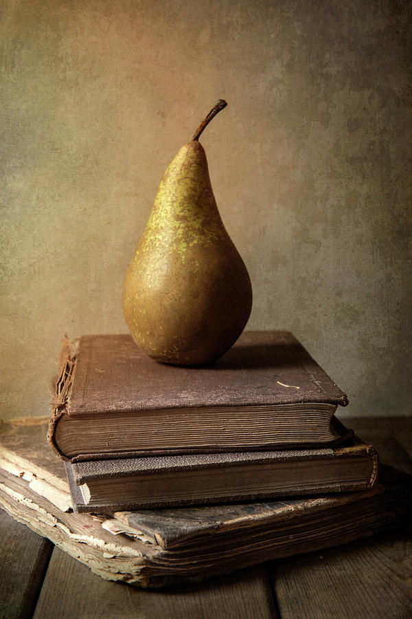 Still life with old books and fresh pear Photograph by Jaroslaw Blaminsky