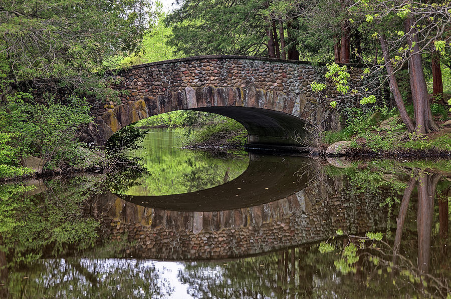 Stone Arch Bridge over still water Photograph by Kyle Lee