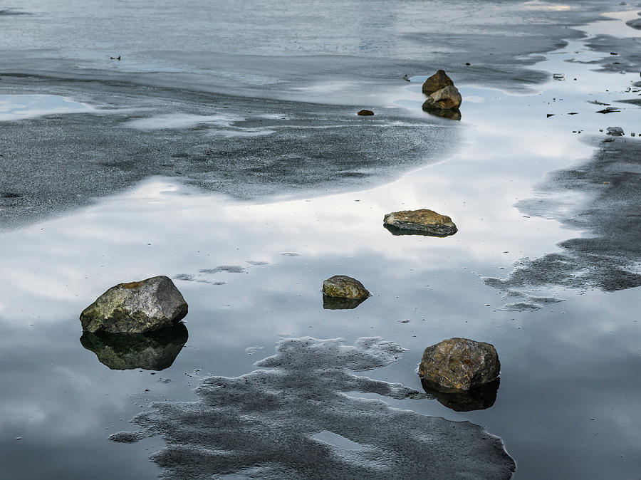 Stones Lying On The Melting Ice Of A Frozen River Photograph