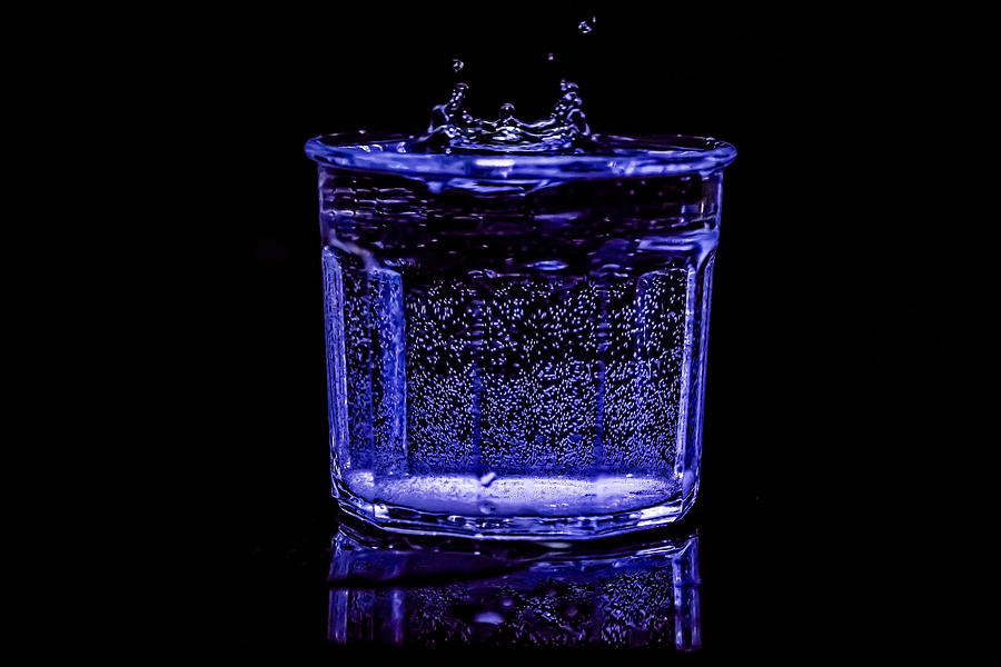 Stop action water drop in blue light Photograph by Sven Brogren