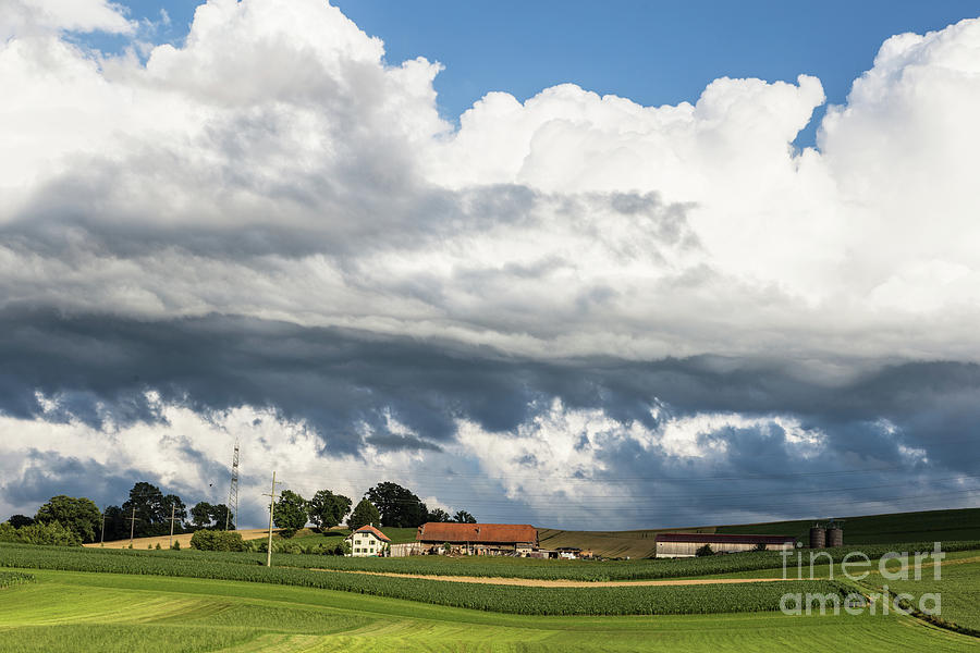 Storm clouds above a farm Photograph by Didier Marti