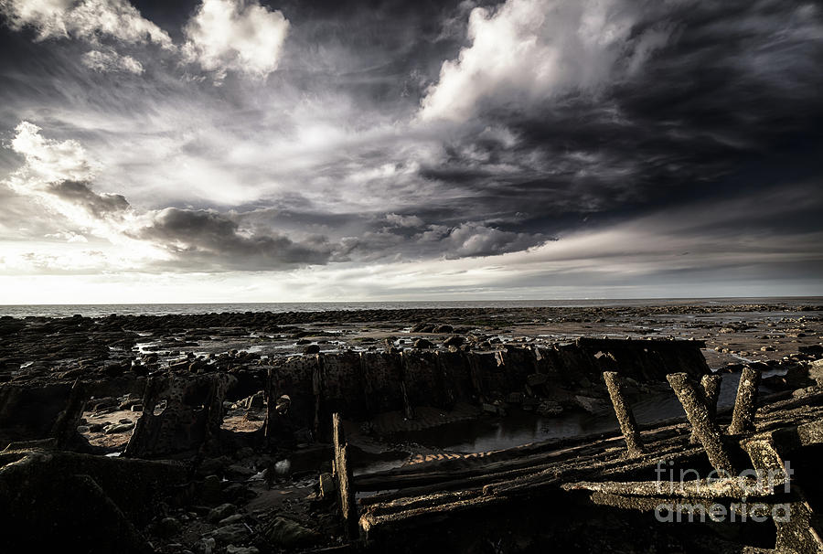 Storm clouds over beached shipwreck Photograph by Simon Bratt