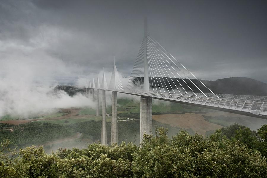 Storm clouds roll in over the Millau viaduct Photograph by Stephen Taylor
